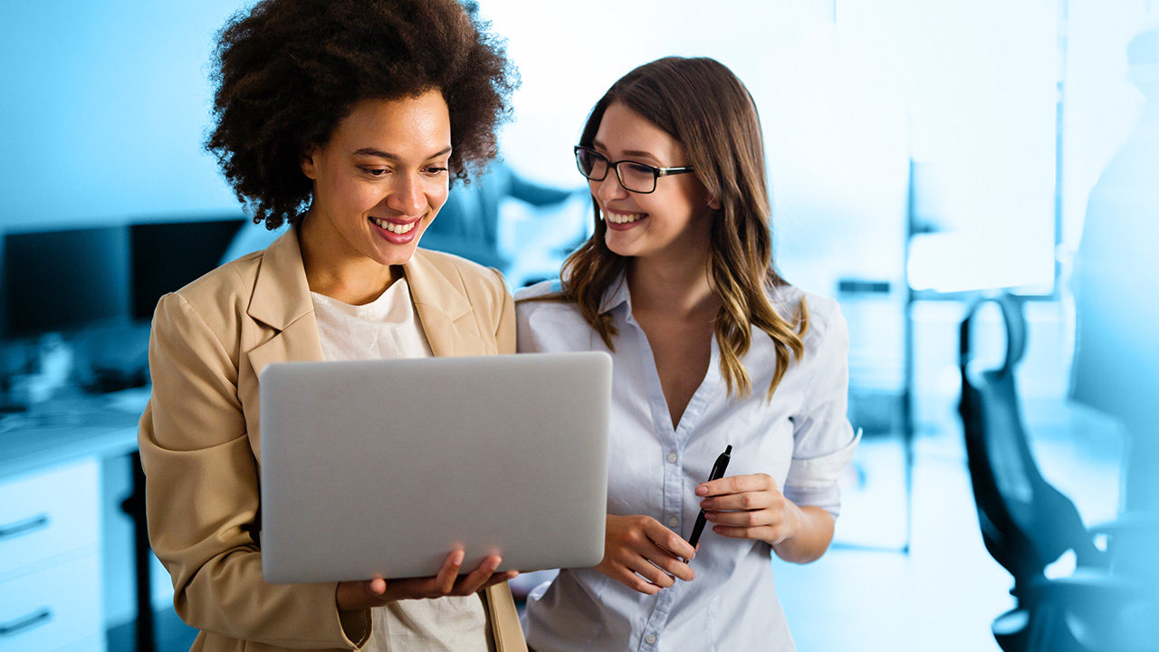 Two women looking at laptop computer